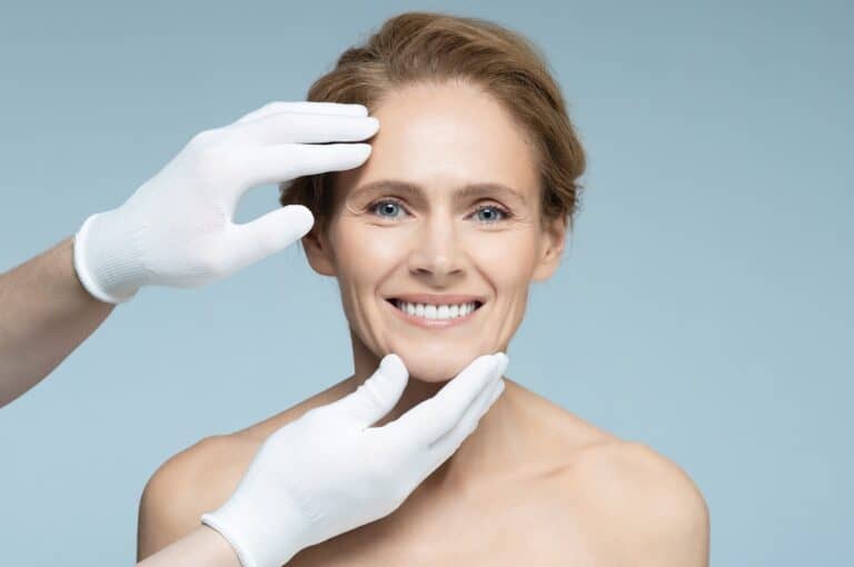 surgeon touching woman face